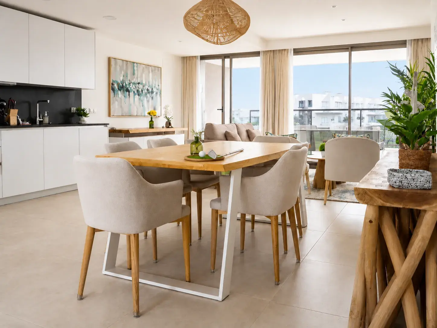 Open-plan living, dining and kitchen opening onto the terrace — Estepona Golf Retreat apartment in Casares Costa